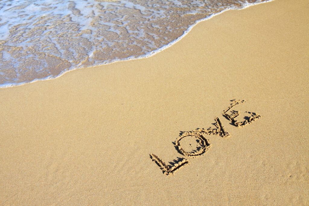 Word Love In Sand; Word love in sand on beach