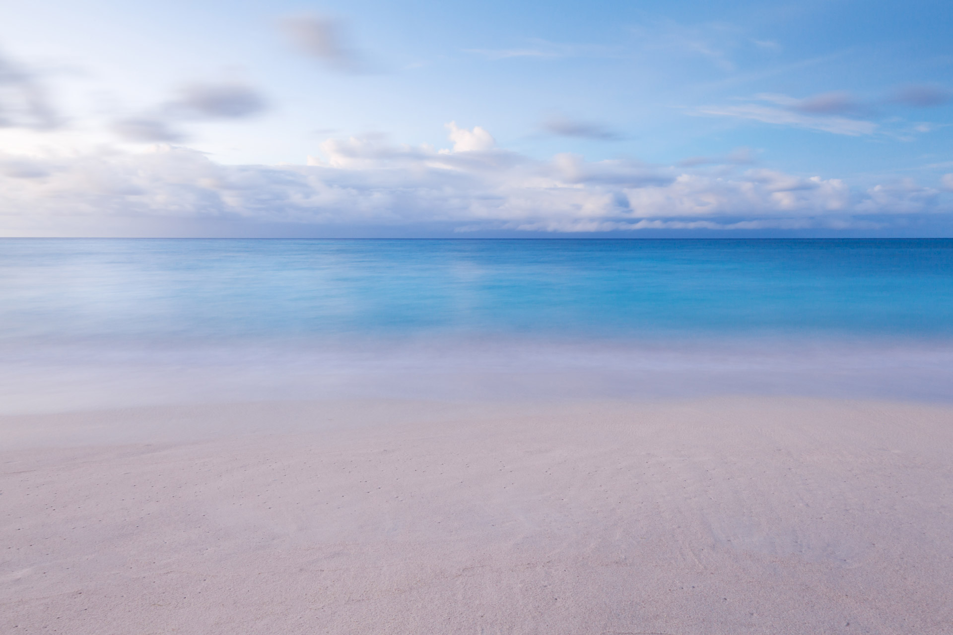 Beach with soft waves and sky in the morning